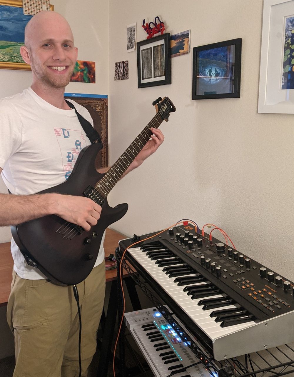 John playing guitar in front of a hydrasynth.